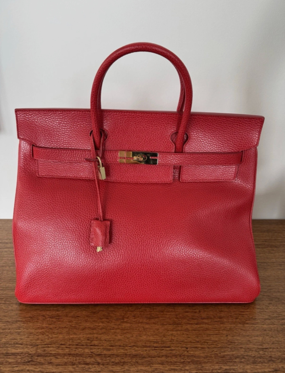 REINA red pebbled leather top handle handbag with gold hardware